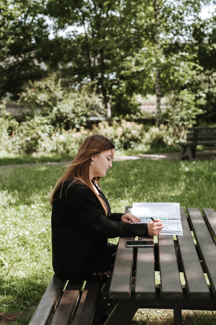 Woman reading and writing notes in diary